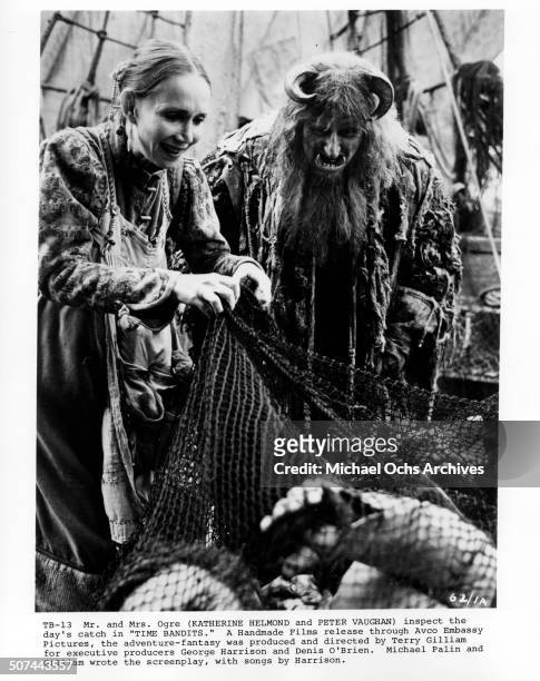 Katherine Helmond and Peter Vaughan as Mr. And Mrs. Ogre inspects the days catch in a scene from the movie "Time Bandits". Circa 1981.