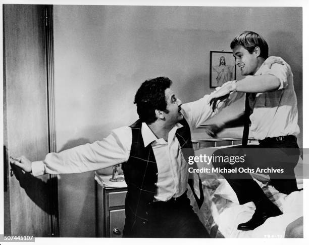Domenico Modugno fights with David McCallum in a scene from the MGM movie "Three Bites of the Apple", circa 1967.