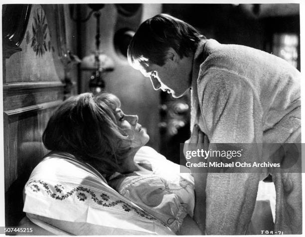 David McCallum goes to the room of Tammy Grimes in a scene from the MGM movie "Three Bites of the Apple", circa 1967.