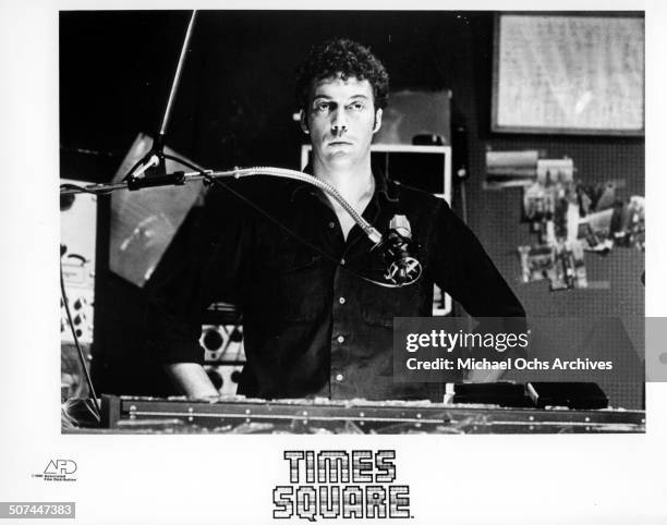 Tim Curry an all night disc jockey stands behind a microphone in a scene from the movie "Times Square" circa 1980.