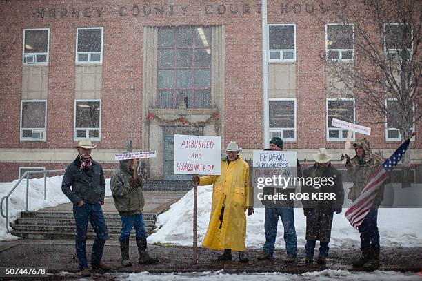 Demonstrators stand near a court house during a protest against government actions in Burns, Oregon on January 29 a day after the FBI released video...