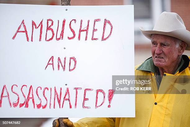 Rancher Monte Siegner holds a sign during a protest against government actions in Burns, Oregon on January 29 a day after the FBI released video...