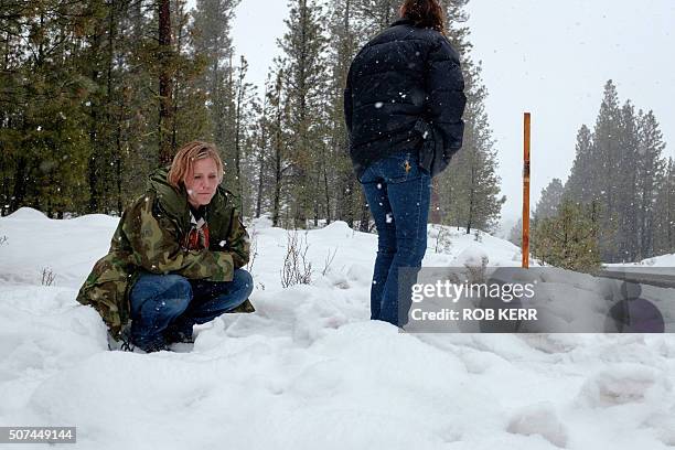 Mandi Jacobs and Jenna Lynn react on Highway 395 near Burns, Oregon on January 29 at the location where Robert "LaVoy" Finicum was shot dead and...