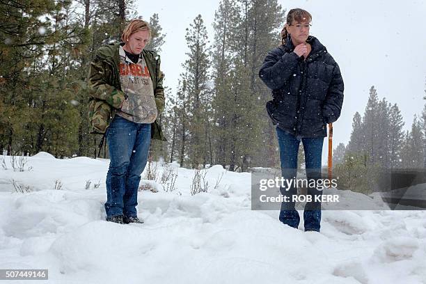 Mandi Jacobs and Jenna Lynn react on Highway 395 near Burns, Oregon on January 29 at the location where Robert "LaVoy" Finicum was shot dead and...