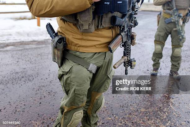 Police monitor a checkpoint near the Malheur Wildlife Refuge near Burns, Oregon on January 29, 2016. Eleven people including Bundy have been arrested...