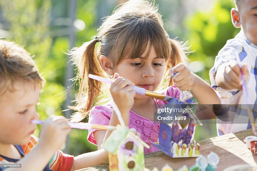 Children painting bird houses