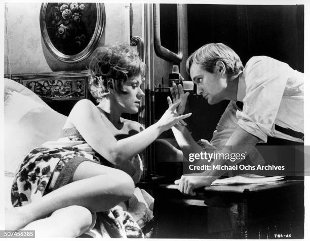 Tammy Grimes does her best to arouse interest from David McCallum in a scene from the MGM movie "Three Bites of the Apple", circa 1967.