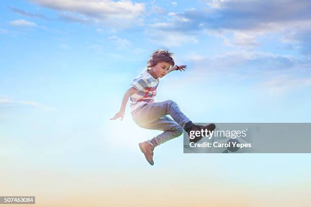 boy jumping in air - jumping ストックフォトと画像
