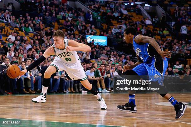 Jonas Jerebko of the Boston Celtics and Keith Appling of the Orlando Magic battle for a loose ball during the fourth quarter at TD Garden on January...