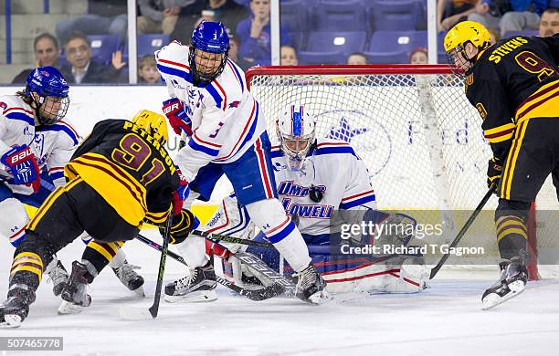 Christoffer Hernberg of the Massachusetts Lowell River Hawks makes a chest save against Garrett Peterson of the Arizona State Sun Devils during NCAA...