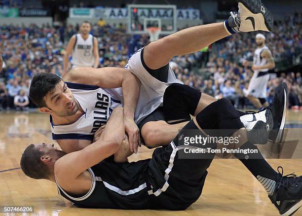 Zaza Pachulia of the Dallas Mavericks scrambles for the ball against Brook Lopez of the Brooklyn Nets in the second half at American Airlines Center...