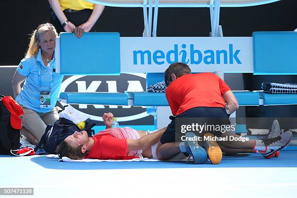 Oliver Anderson of Australia receives medical attention in his Junior Boys' Singles Final match against Jurabeck Karimov of Uzbekistan during the...