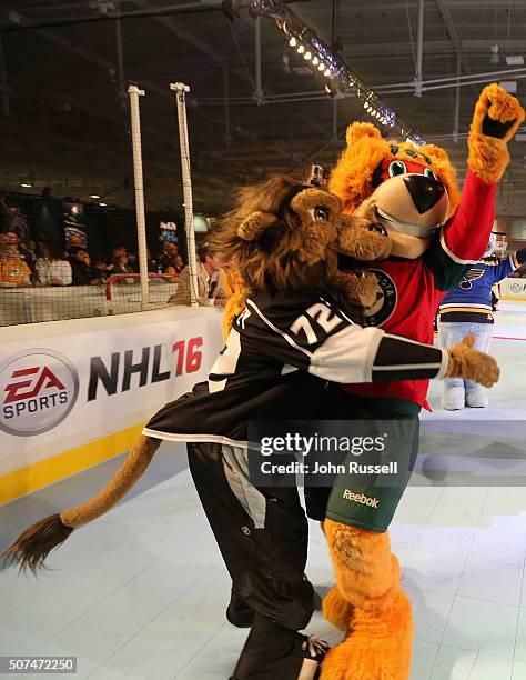 The Los Angeles Kings mascot, Bailey, and the Minnesota Wild mascot, Nordy, celebrate during the NHL Mascot Showdown during day two of the 2016 NHL...