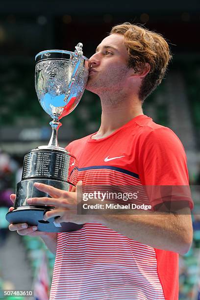 Oliver Anderson of Australia poses with the championship trophy after winning his Junior Boys' Singles Final match against Jurabeck Karimov of...