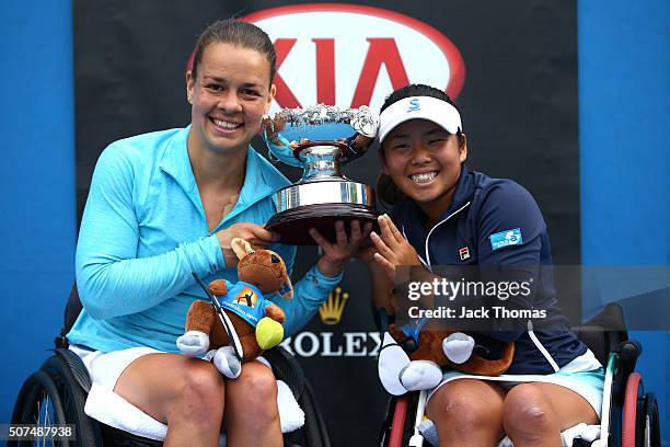 Marjolein Buis of the Netherlands and Yui Kamiji of Japan pose with the trophy after winning the Women's Wheelchair Doubles Final match against Jiske...