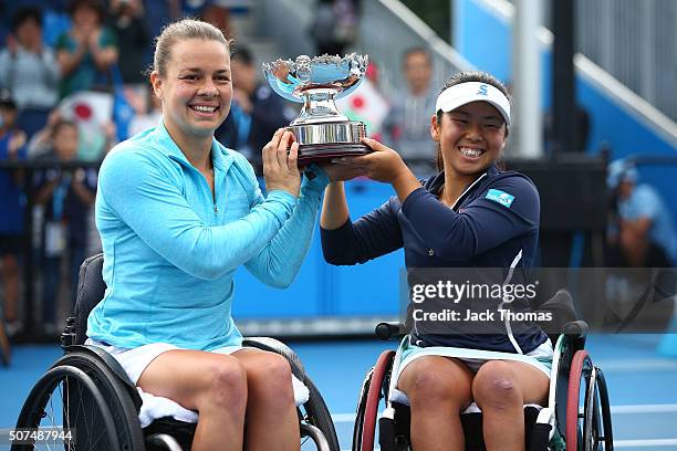 Marjolein Buis of the Netherlands and Yui Kamiji of Japan pose with the trophy after winning the Women's Wheelchair Doubles Final match against Jiske...