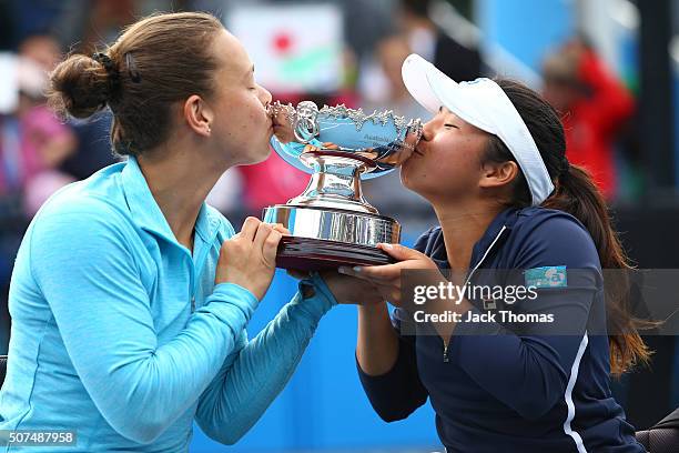 Marjolein Buis of the Netherlands and Yui Kamiji of Japan pose with the trophy after winning the Women's Wheelchair Doubles Final match against Jiske...