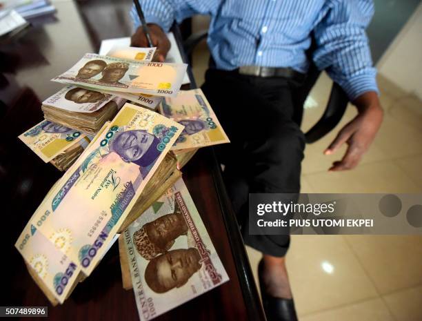 This picture taken on January 28, 2016 in Lagos shows naira banknotes, Nigeria's currency. - Nigeria's central bank governor, Godwin Emefiele, on...
