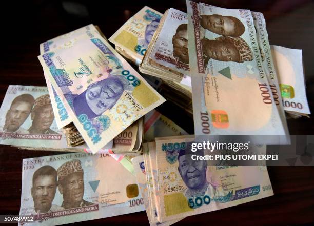 This picture taken on January 28, 2016 in Lagos shows naira banknotes, Nigeria's currency. - Nigeria's central bank governor, Godwin Emefiele, on...