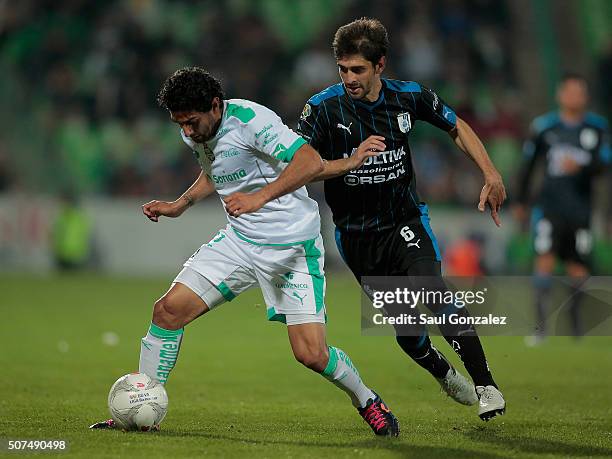 Martin Bravo of Santos struggles for the ball with Juan Forlin of Queretaro during the fourth round match between Santos Laguna and Queretaro as part...