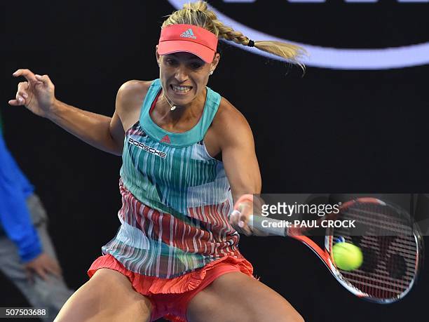Germany's Angelique Kerber hits a return against Serena Williams of the US during their women's singles final on day thirteen of the 2016 Australian...