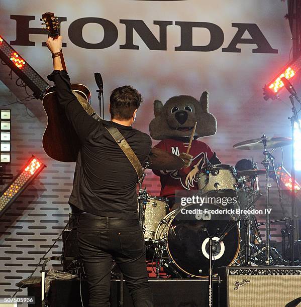 Steven Lee Olsen is joined on stage by Phoenix Coyotes mascot Howler during a performance on the Honda Stage at the NHL Fan Fair presented by...