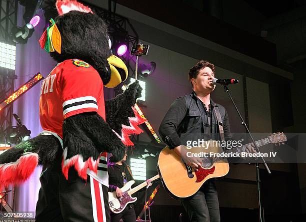 Chicago Blackhawks mascot Tommy Hawk takes a selfie with Steven Lee Olsen during a performance on the Honda Stage at the NHL Fan Fair presented by...