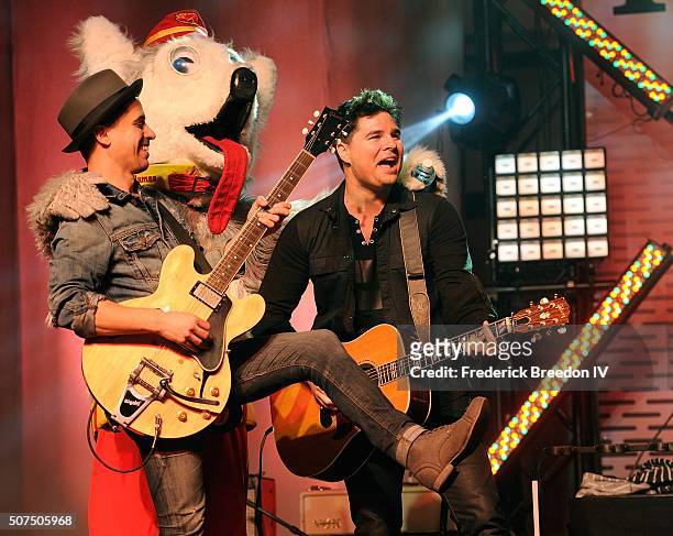 Guitarist Corey Congilio and Steven Lee Olsen are joined on stage by Calgary Flames mascot Harvey the Hound during a performance on the Honda Stage...