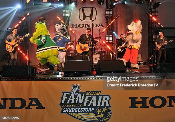 Steven Lee Olsen is joined on stage by NHL mascots Victor E. Green, of the Dallas Stars, Louie, of the St. Louis, and Harvey the Hound of the Calgary...