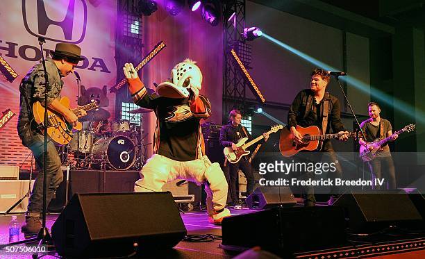 Guitarist Corey Congilio and vocalist Steven Lee Olsen are joined on stage by Anaheim Wild Ducks mascot Mighty Wing during a performance on the Honda...
