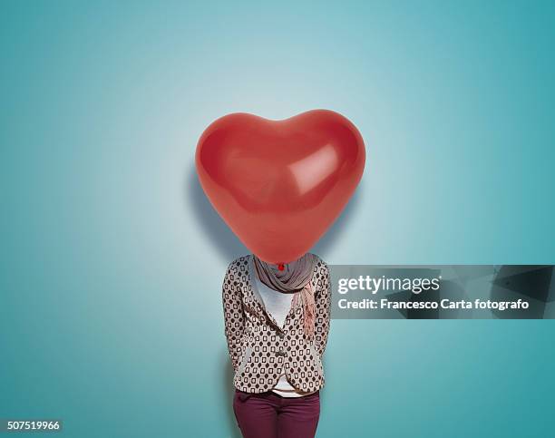 woman with red heart-shaped balloon - blind date stock pictures, royalty-free photos & images