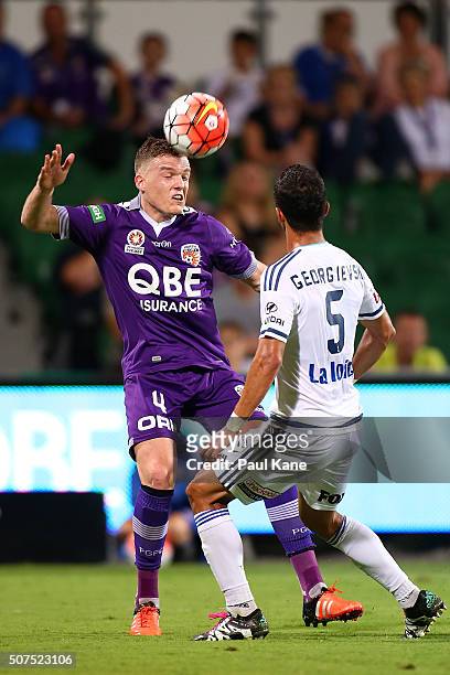 Shane Lowry of the Glory heads the ball against Daniel Georgievski of the Victory during the round 17 A-League match between Perth Glory and...