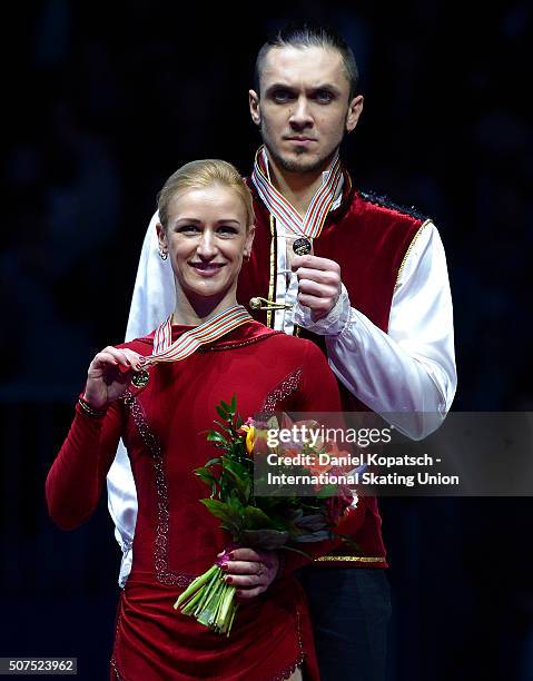 Gold medalists Tatiana Volosozhar and Maxim Trankov of Russia pose during the medal ceremony of Pairs Skating on day four of the ISU European Figure...