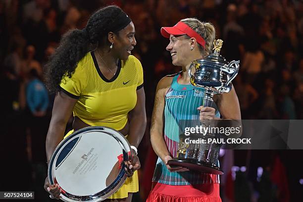 Angelique Kerber of Germany holds the winner's trophy during the awards ceremony following her victory over Serena Williams of the US in their...