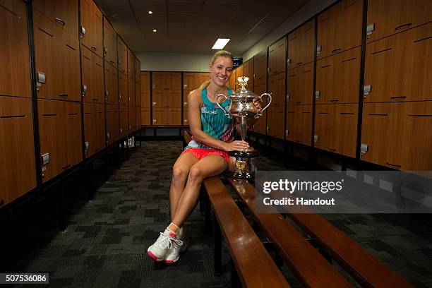 In this handout photo provided by Tennis Australia, Angelique Kerber of Germany poses with the Daphne Akhurst Trophy in the players change rooms...