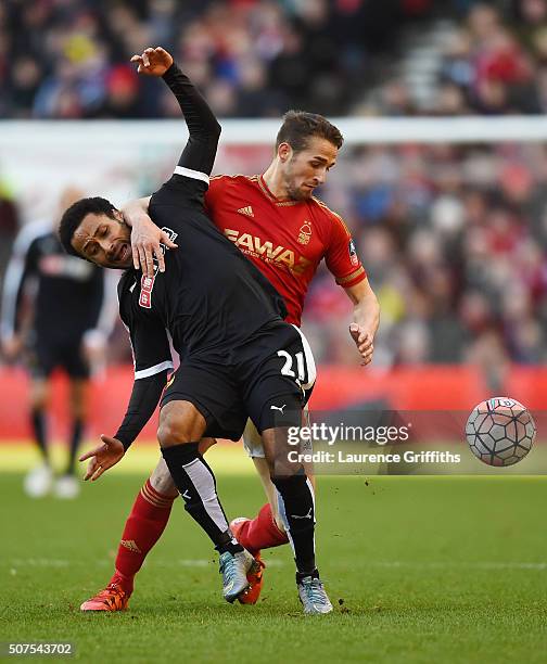 Ikechi Anya of Watford and Chris Cohen of Nottingham Forest compete for the ball during The Emirates FA Cup fourth round between Nottingham Forest...