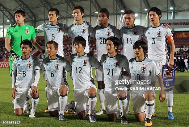 Japan's starting eleven pose for a group picture ahead of their AFC U23 Championship final football match between Japan and South Korea at Abdullah...