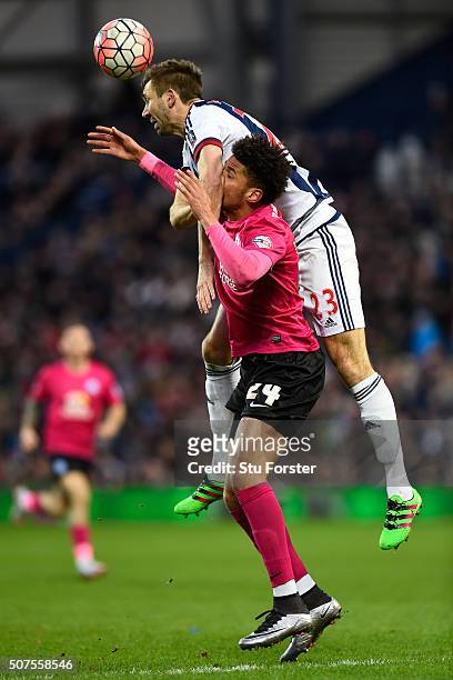 Gareth McAuley of West Bromwich Albion and Lee Angol of Peterborough United compete for the ball during the Emirates FA Cup Fourth Round match...