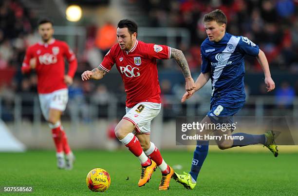 Lee Tomlin of Bristol City looks to break past Stephen Gleeson of Birmingham City during the Sky Bet Championship match between Bristol City and...