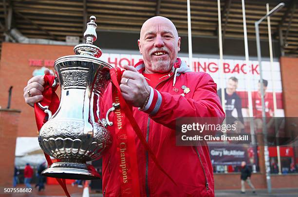 Fan poses with the FA Cup trophy prior to the Emirates FA Cup Fourth Round match between Liverpool and West Ham United at Anfield on January 30, 2016...
