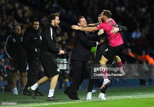 Jon Taylor of Peterborough United celebrates scoring his team's second goal with manager Graham Westley and staffs during the Emirates FA Cup Fourth...