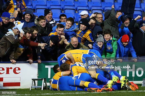 Jack Grimmer of Shrewsbury Town is mobbed by his team mates and fans after he scores to make it 3-2 during the Emirates FA Cup match between...
