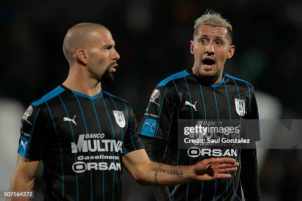 Emanuel Villa of Queretaro talks to his teammate Yaser Corona during the fourth round match between Santos Laguna and Queretaro as part of the...