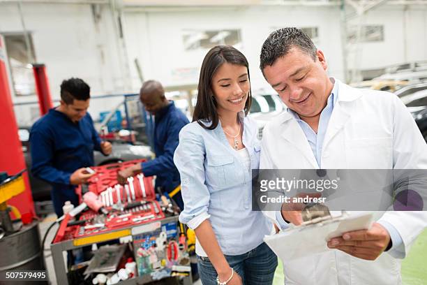 woman at the mechanic - happy client by broken car stock pictures, royalty-free photos & images