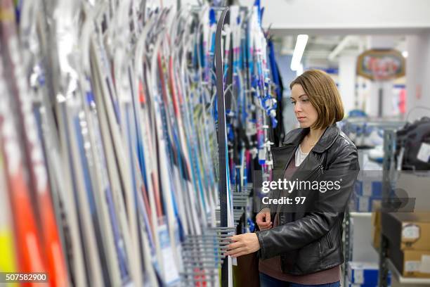 woman buys skis - sports equipment store stock pictures, royalty-free photos & images