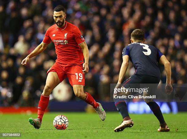 Steven Caulker of Liverpool is watched by Aaron Cresswell of West Ham United during the Emirates FA Cup Fourth Round match between Liverpool and West...