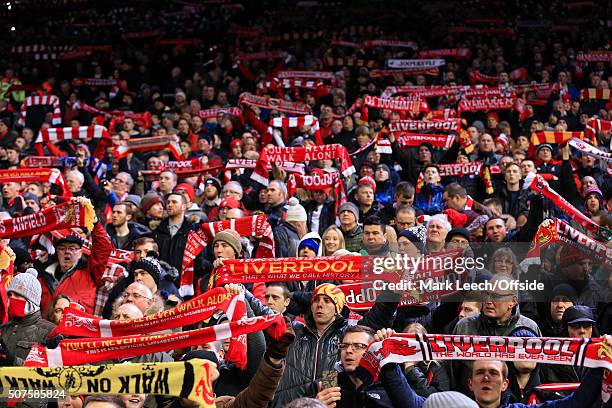 Liverpool fans hold their scarves aloft as they sing 'You'll Never Walk Alone' before the Emirates FA Cup Third Round Replay match between Liverpool...