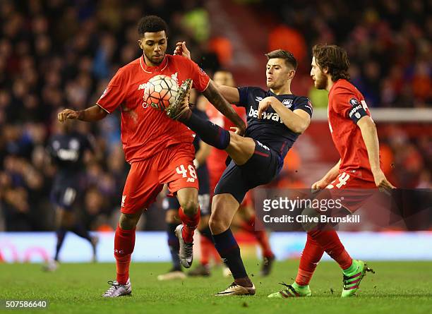 Aaron Cresswell of West Ham United battles with Jerome Sinclair and Joe Allen of Liverpool during the Emirates FA Cup Fourth Round match between...