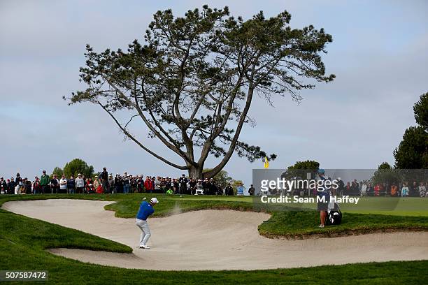 Dustin Johnson hits a shot out of a bunker on the 1st hole during Round 3 of the Farmers Insurance Open at Torrey Pines South on January 30, 2016 in...
