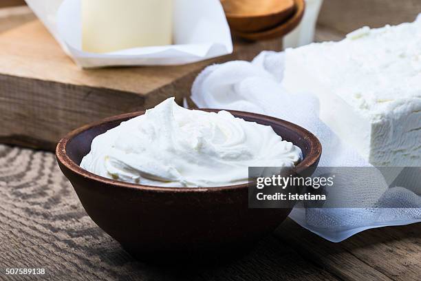 sour cream. organic dairy products on rustic wooden table - curd cheese stock pictures, royalty-free photos & images